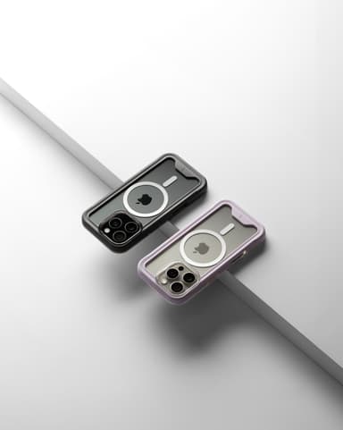 A black-bumper and a purple-bumper ZIZO ION MagSafe case rear-facing on a white ledge with a gray step running diagonally behind them