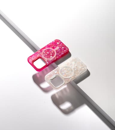 ZIZO JEWEL cases in a glitter-crystal, holographic pattern — hot pink and opal white, angled with dramatic shadow