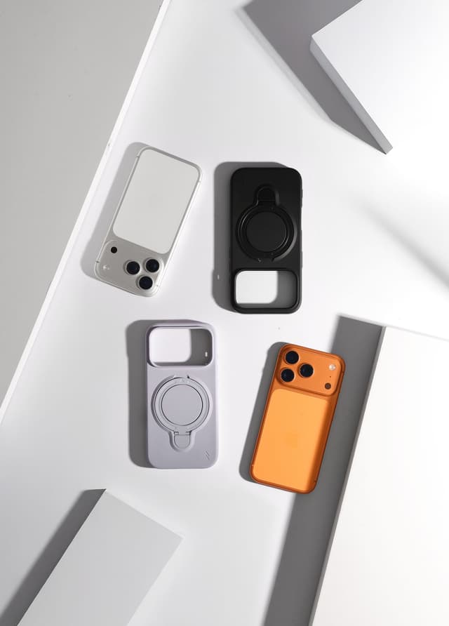 Four ZIZO Revolve ring-stand cases flat-laid across angled white studio blocks, two of them fitted on iPhones