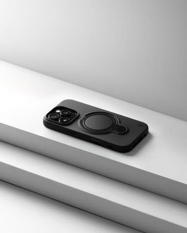A matte black ZIZO Revolve case on an iPhone, resting on stair-stepped studio blocks in soft directional light