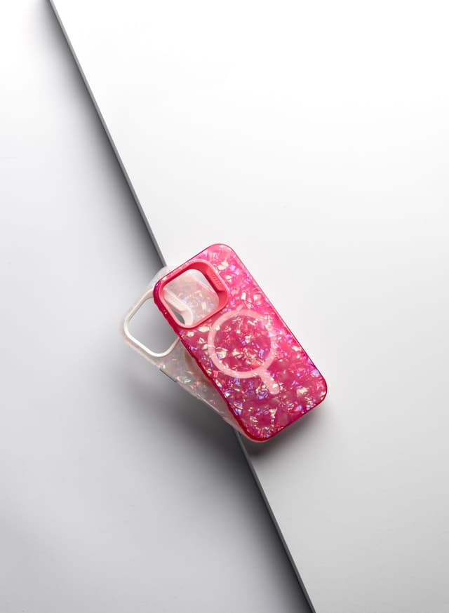 Two ZIZO JEWEL cases side by side — a pink crystal finish and a clear iridescent finish, MagSafe ring visible on each