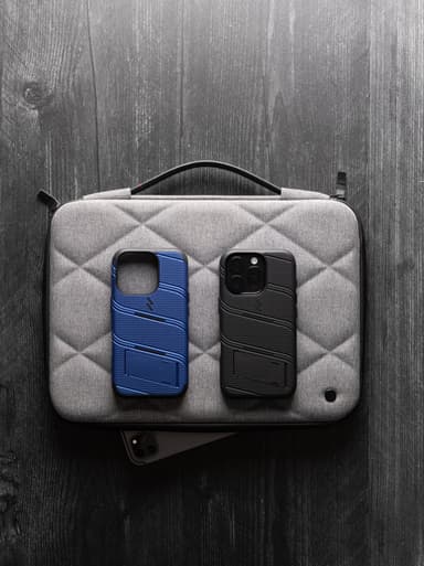 Two ZIZO Bolt cases, blue and black, with their built-in kickstands popped open on a laptop sleeve