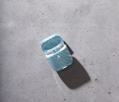 A pale blue translucent ZIZO Halos charging case, open, on gray concrete