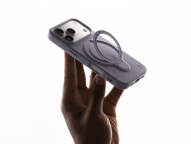 ZIZO Revolve case in muted lavender-gray on an iPhone Pro, held in hand with the built-in ring flipped open into kickstand mode