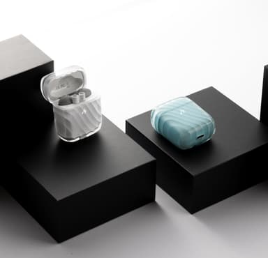 Two ZIZO Halos charging cases, one frosted clear and one pale blue, staged on black plinths