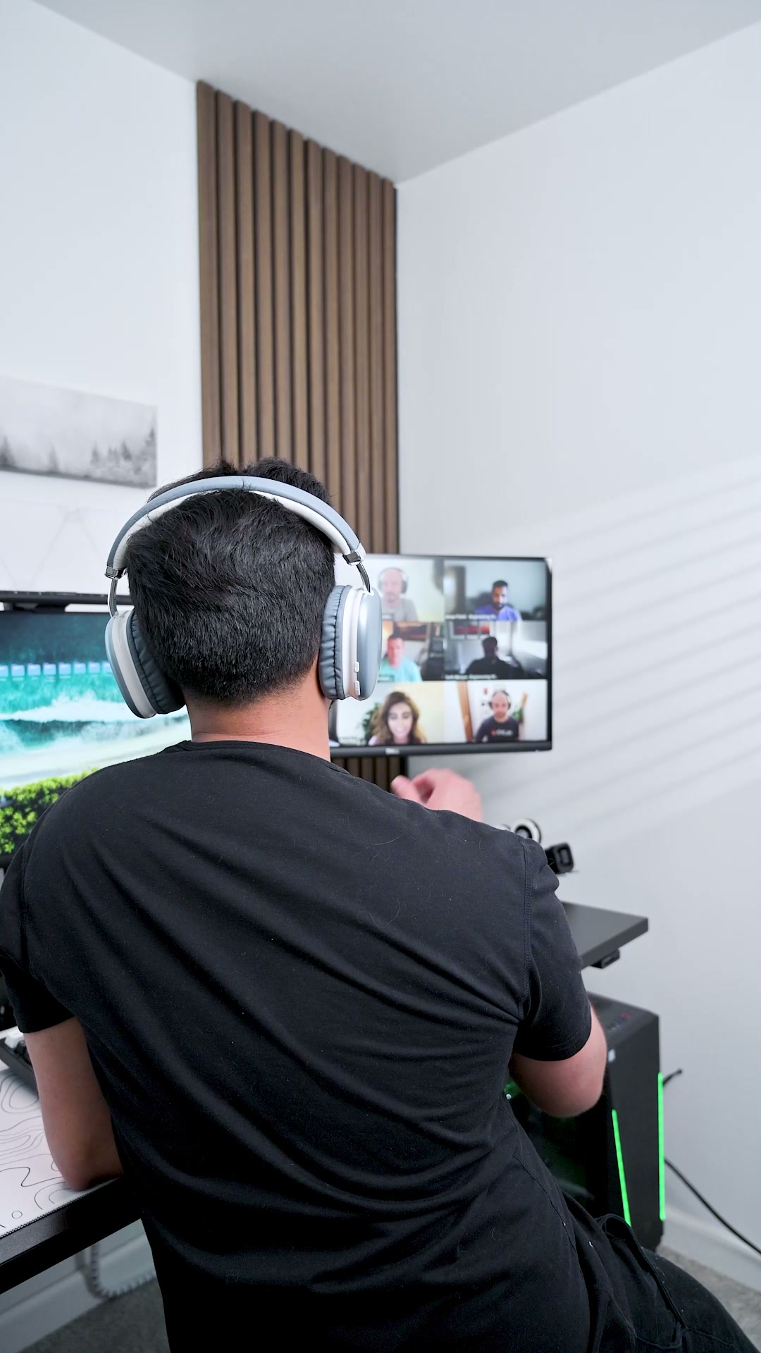 A person seen from behind on a video call, wearing pale ZIZO Tempo Pro headphones