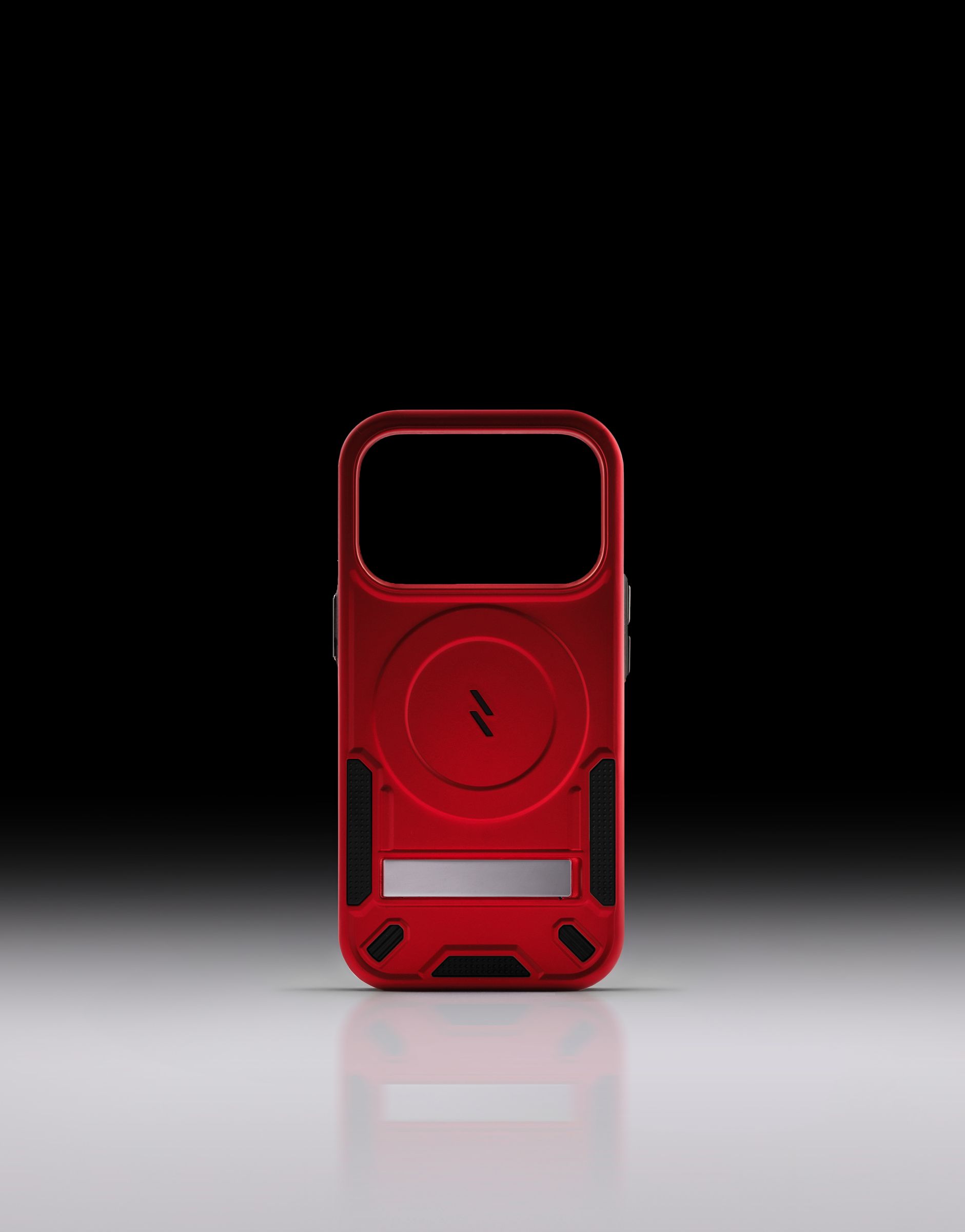 A red ZIZO Transform case shown rear-facing against a black-to-white gradient, its MagSafe ring, kickstand and textured corners visible