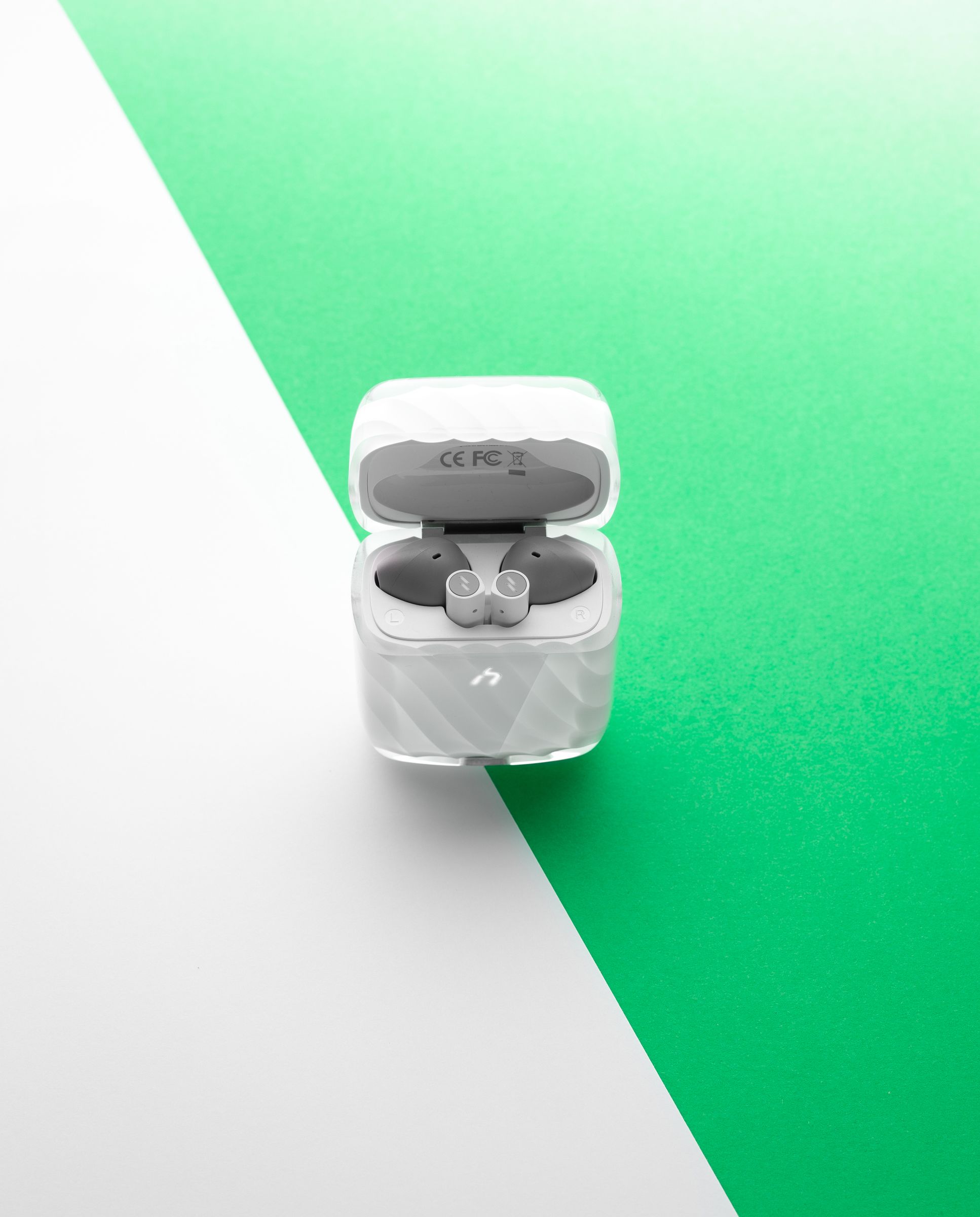 An open ZIZO Halos case showing both earbuds seated inside