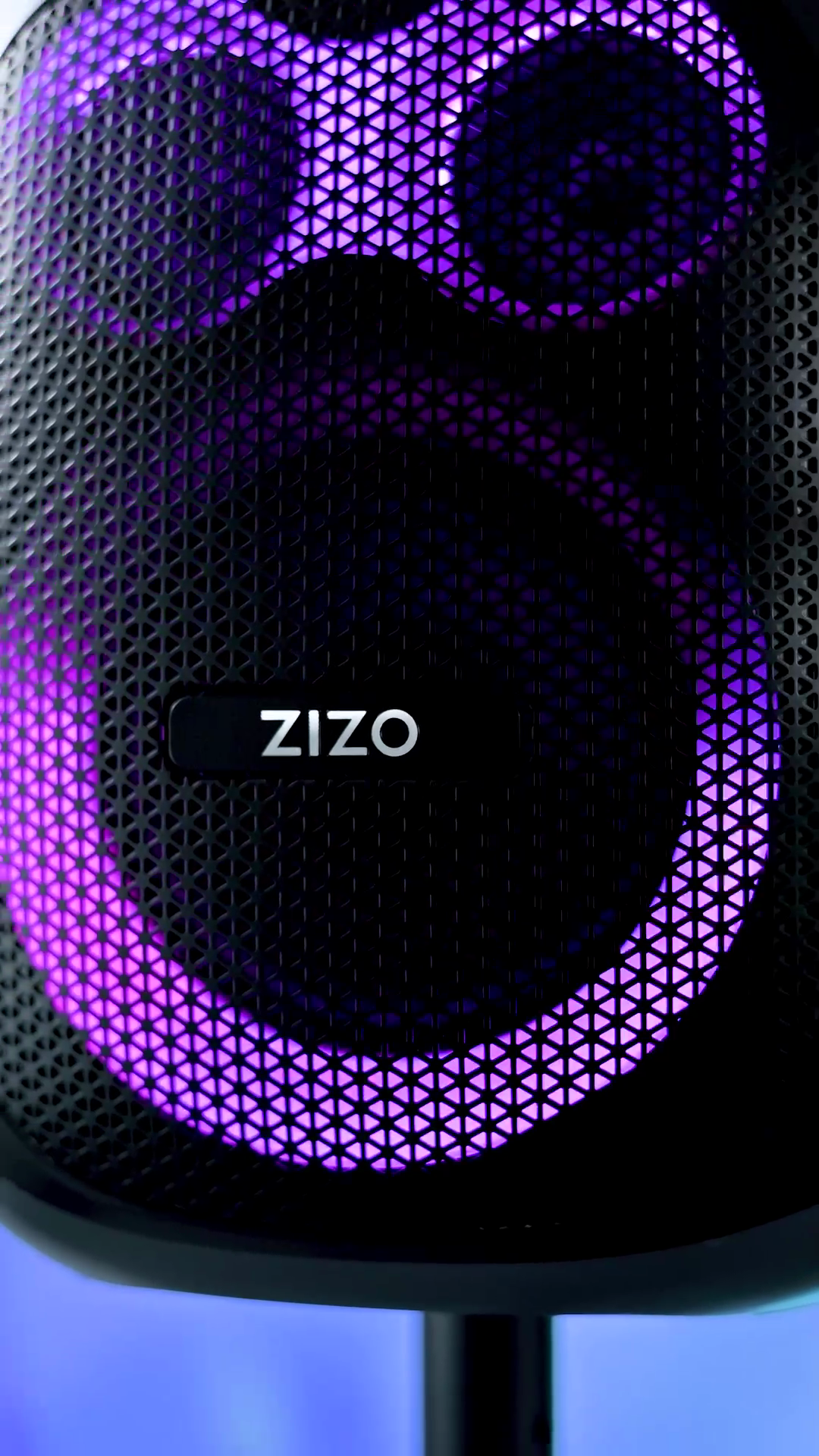 The ZIZO Tune Z5 party speaker's honeycomb grille lit magenta, two driver rings glowing around the centered ZIZO badge