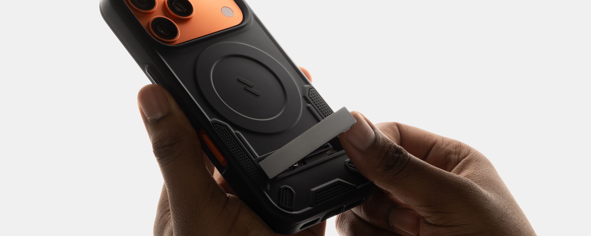 Close-up of hands sliding open the silver kickstand on a black ZIZO Transform MagSafe case