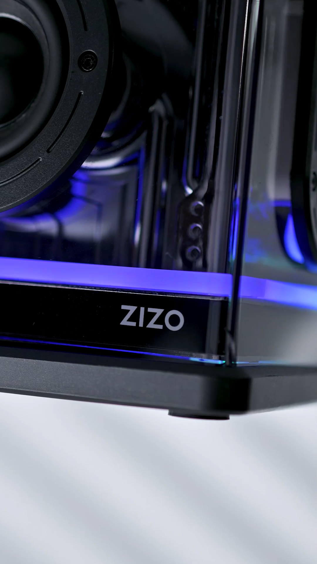 The ZIZO wordmark on the base of the Retro Crystal speaker, with the RGB light bar glowing violet along its front edge