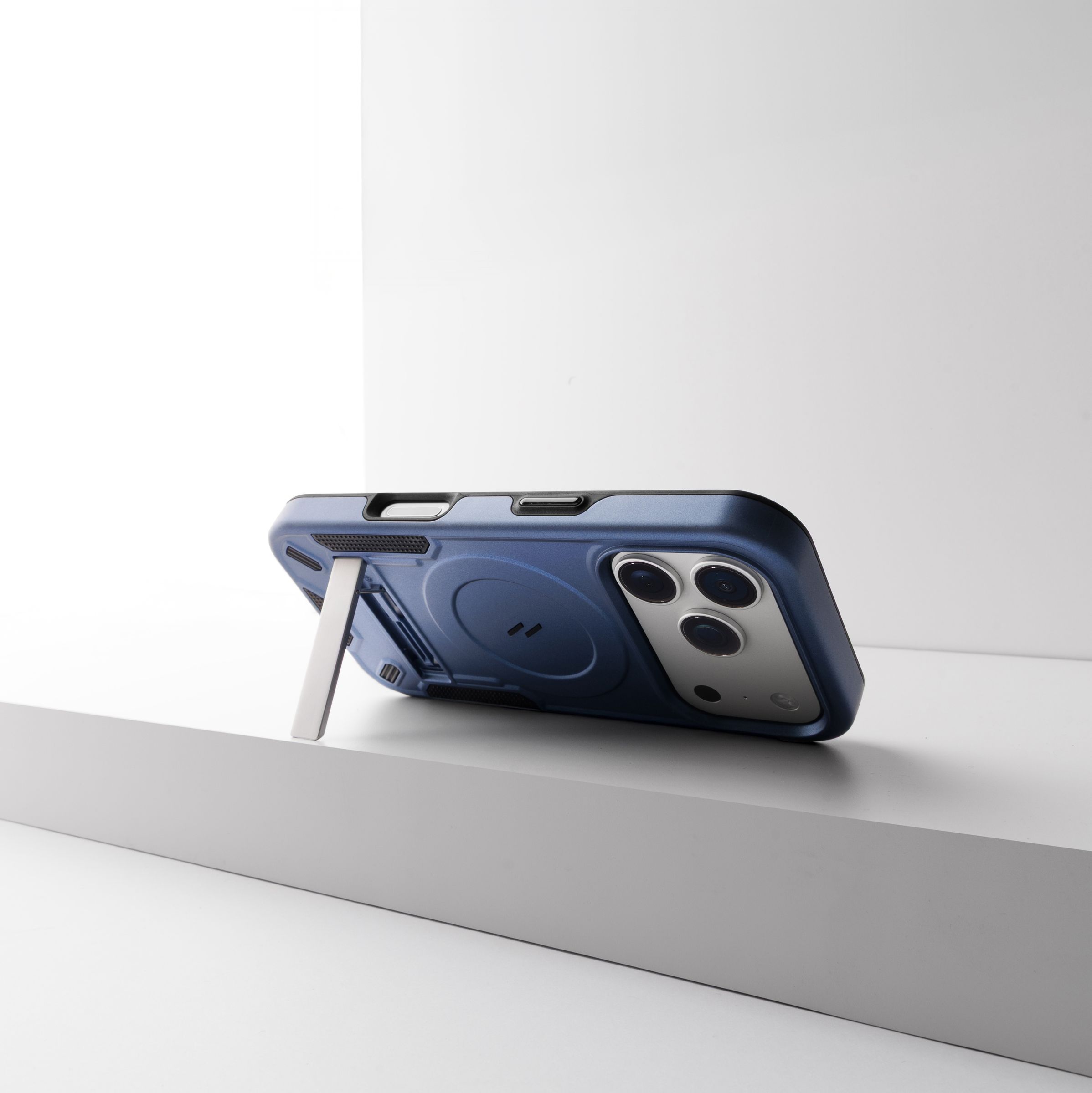 ZIZO Transform MagSafe case in blue from a low three-quarter view, kickstand deployed and holding the phone upright