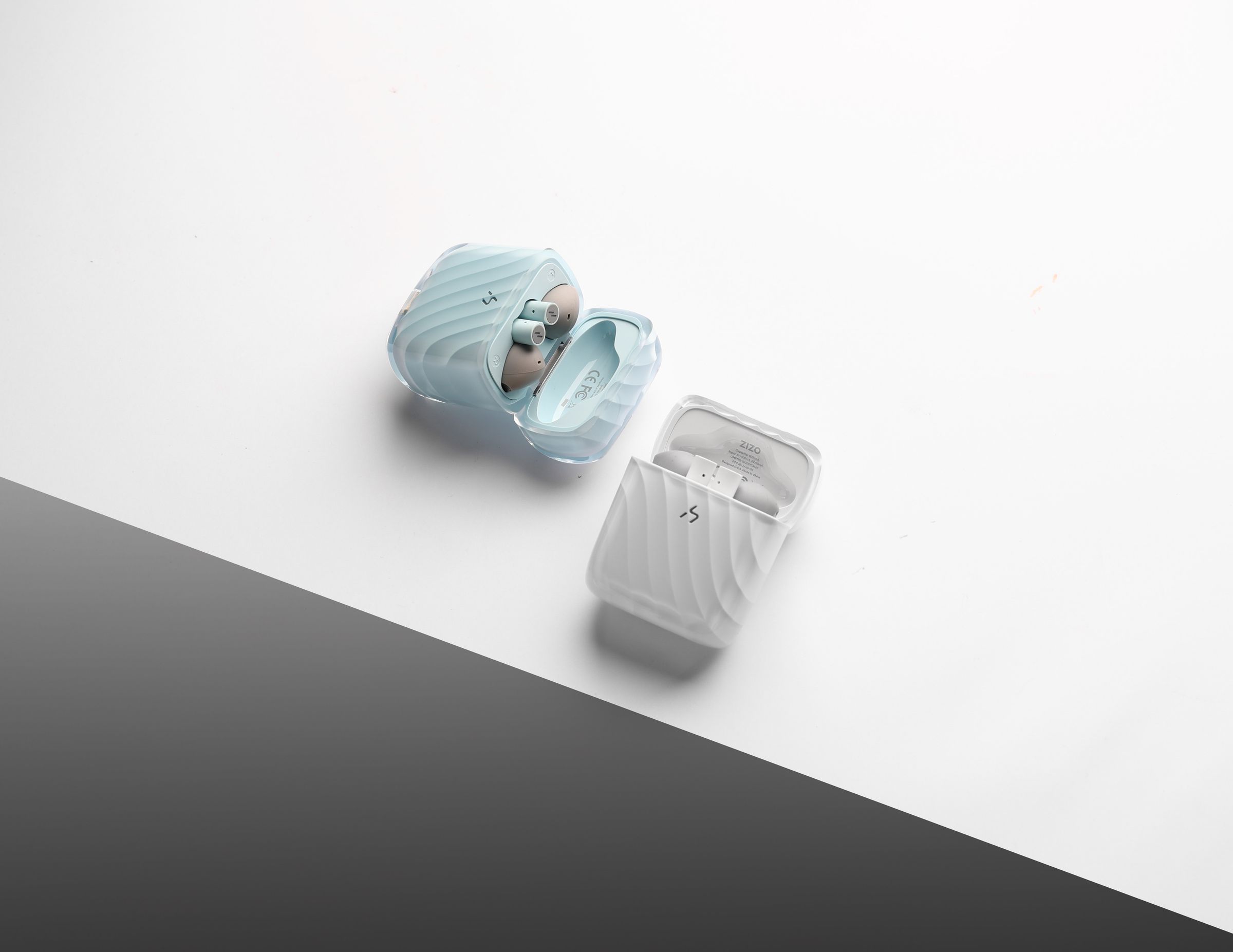 Two ZIZO Halos cases on a split white and charcoal background