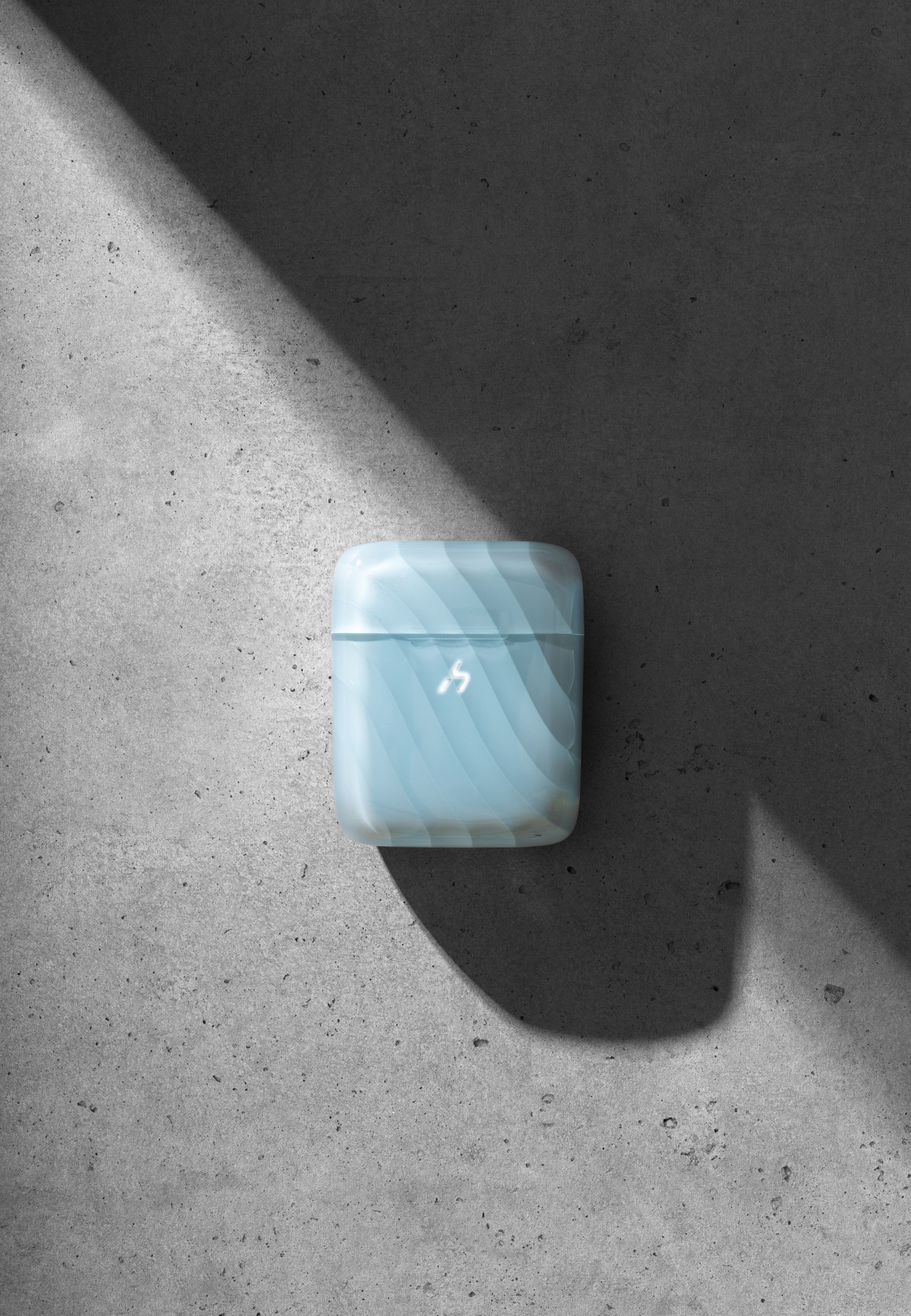 A pale blue translucent ZIZO Halos case closed, on gray concrete